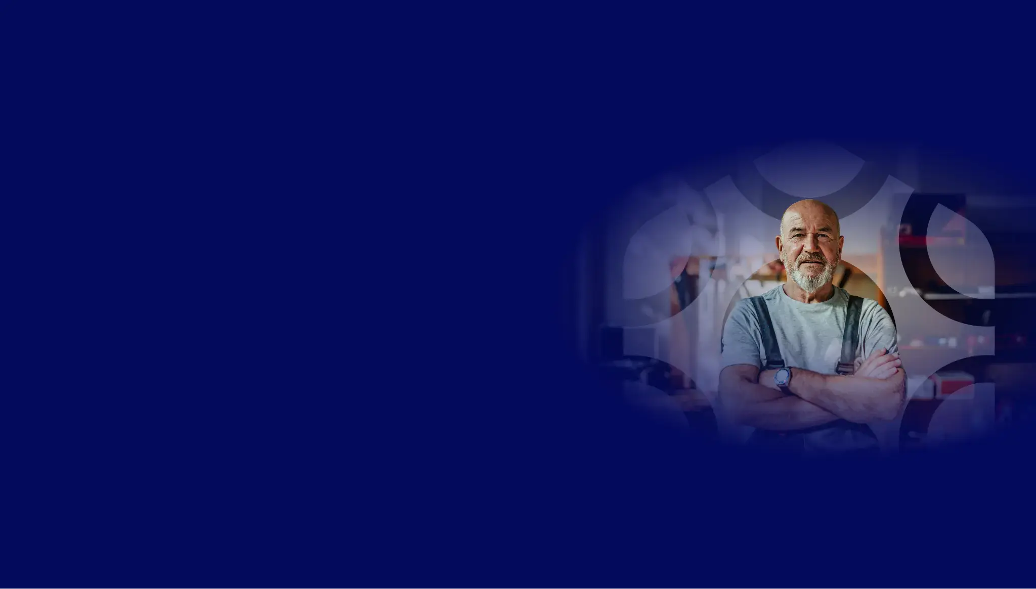 A deep blue background covers the top of the page, with a watermarked version of the hexagonal logo shape overlaid on an image of a mature man wearing a hat, with his arms crossed standing in a workshop, looking confident and in control.